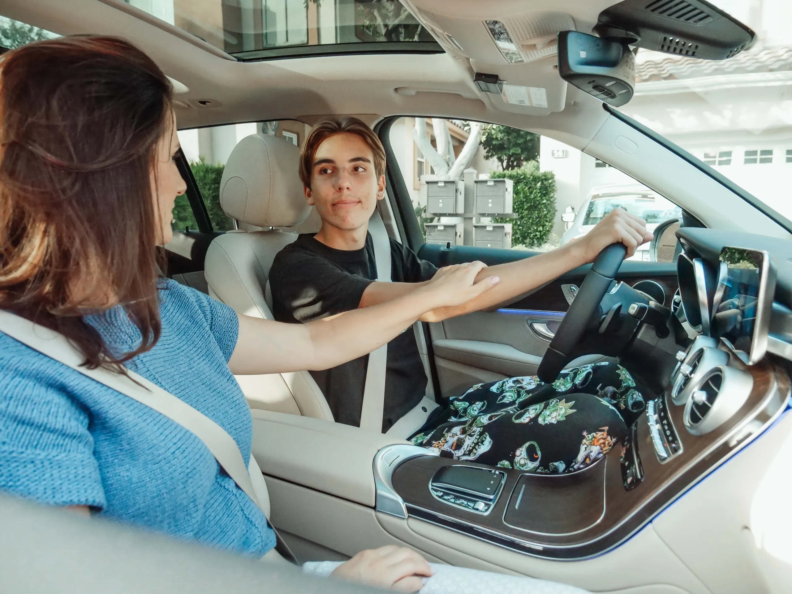 Instructor guiding a teen driver